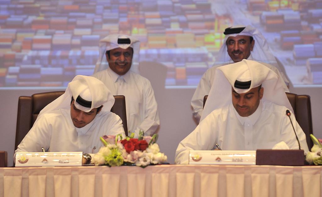 HE Jassim Saif Ahmed Al Sulaiti , Minister of Transport and Communication (standing-right) and Sheikh Ali bin Jassim Al-Thani, Milaha Chairman and Managing Director (standing-left), witnessing the signing of MoU by Abdulrahman Essa Al Mannai, Executive Di