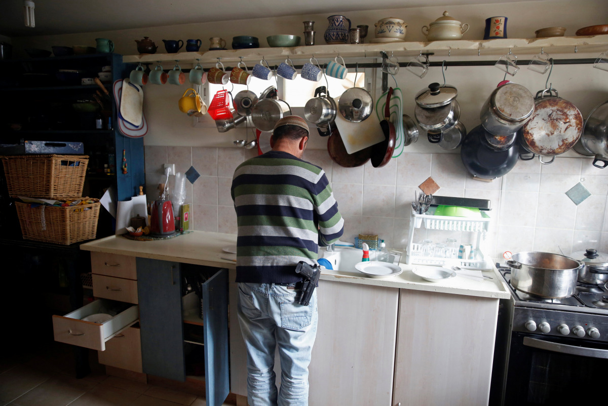 Elad Ziv prepares food in his home in the Jewish settler outpost of Amona in the West Bank, November 22, 2016. Picture taken November 22, 2016. REUTERS/Ronen Zvulun