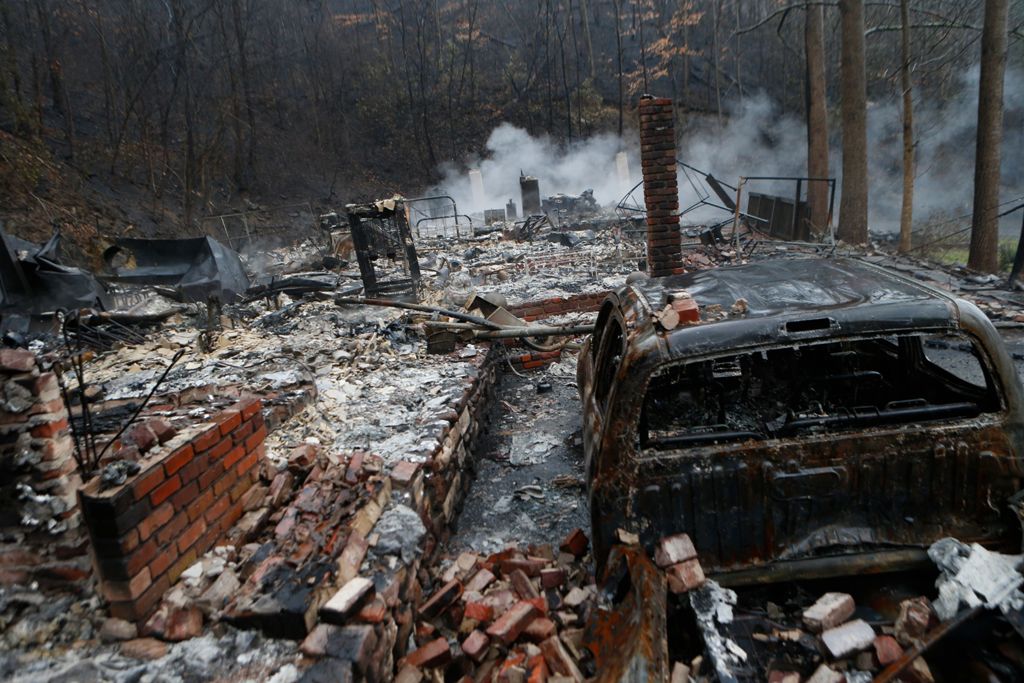 GATLINBURG, TN - NOVEMBER 30: The remains of a home smolder in the wake of a wildfire November 30, 2016 in Gatlinburg, Tennessee. / AFP.