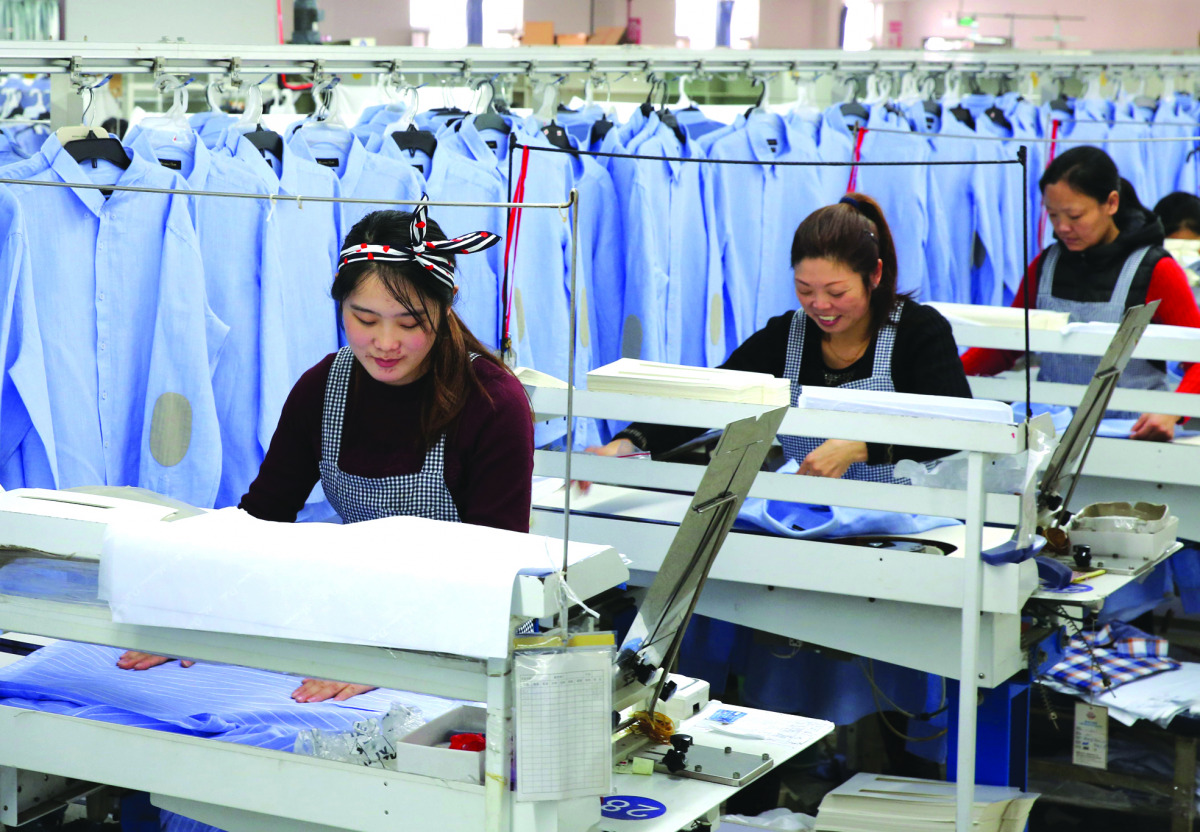Women work in a shirt factory in Nantong, in China's Jiangsu province, yesterday.  China's manufacturing activity growth accelerated in November, official data showed.