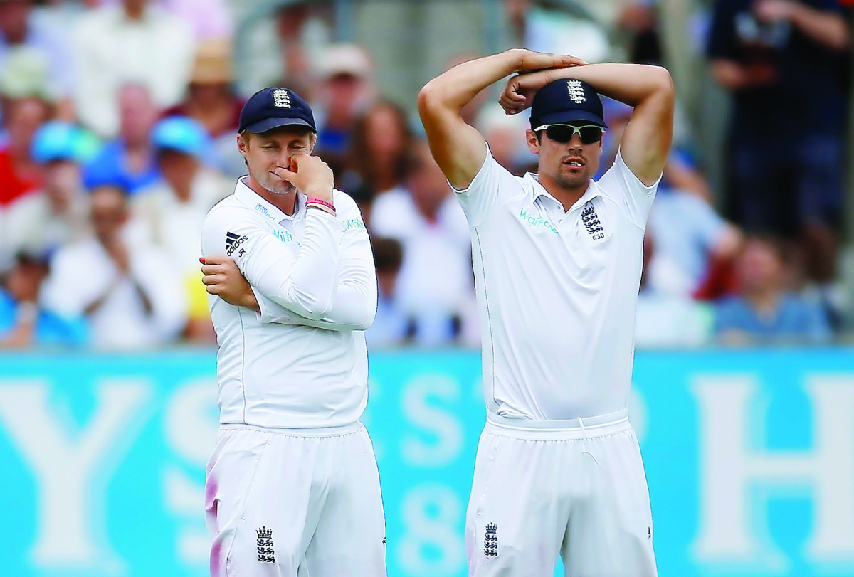England’s Joe Root and Alastair Cook (right) look dejected after a missed chance during the fourth Test match against Pakistan at the Oval in at Edgbaston in this August 13 file photo.