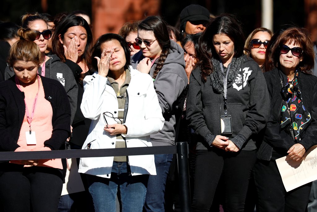 Attendees bow their heads during a memorial event at the Inland Regional Center on the one year anniversary of the San Bernardino attack in San Bernardino, California, U.S. December 2, 2016. REUTERS/Patrick T. Fallon