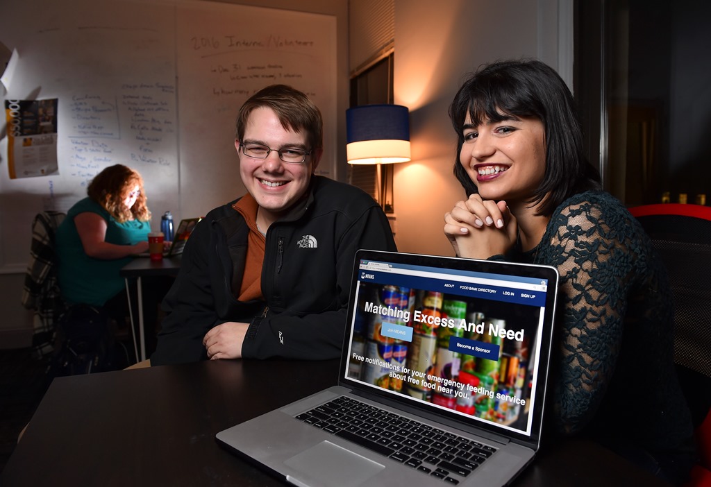MEANS Database's Maria Rose Belding, co-founder and executive director, right, along with Grant Nelson, chief operating officer, pose for a photo with their homepage visible on the screen in their office at American University on December 4, 2015 in Washi