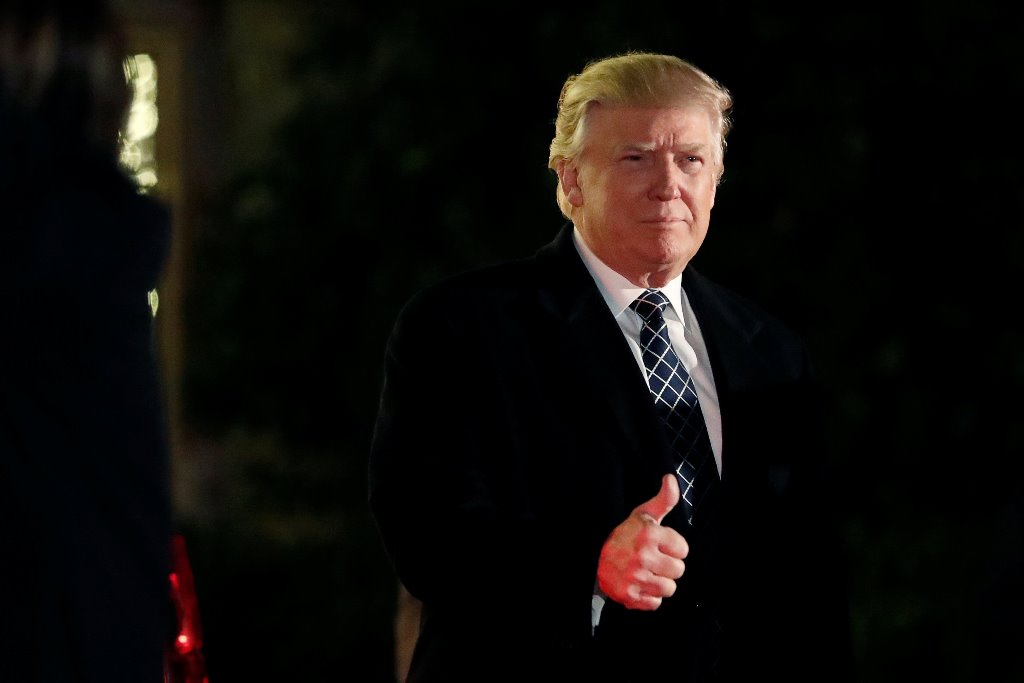 U.S. President-elect Donald Trump gives a thumbs up to the media as he arrives at a costume party at the home of hedge fund billionaire and campaign donor Robert Mercer in Head of the Harbor, New York, U.S., December 3, 2016. REUTERS/Mark Kauzlarich
