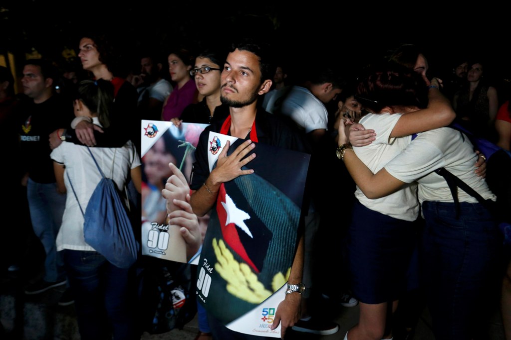 University students react while watching the television transmission of the event being held in Santiago de Cuba in honor of former President Fidel Castro, in Havana, Cuba, December 3, 2016. REUTERS/Stringer EDITORIAL USE ONLY. NO RESALES. NO ARCHIVE