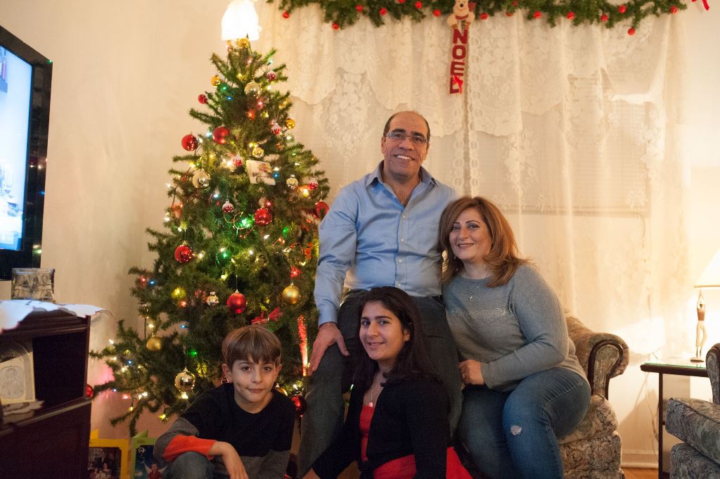 (Clockwise from top) Fahed, Jouli, Sparta and Adeeb Fattouh pose in the living room of their apartment in Laval, Canada, on November 30, 2016. AFP / Catherine Legault 