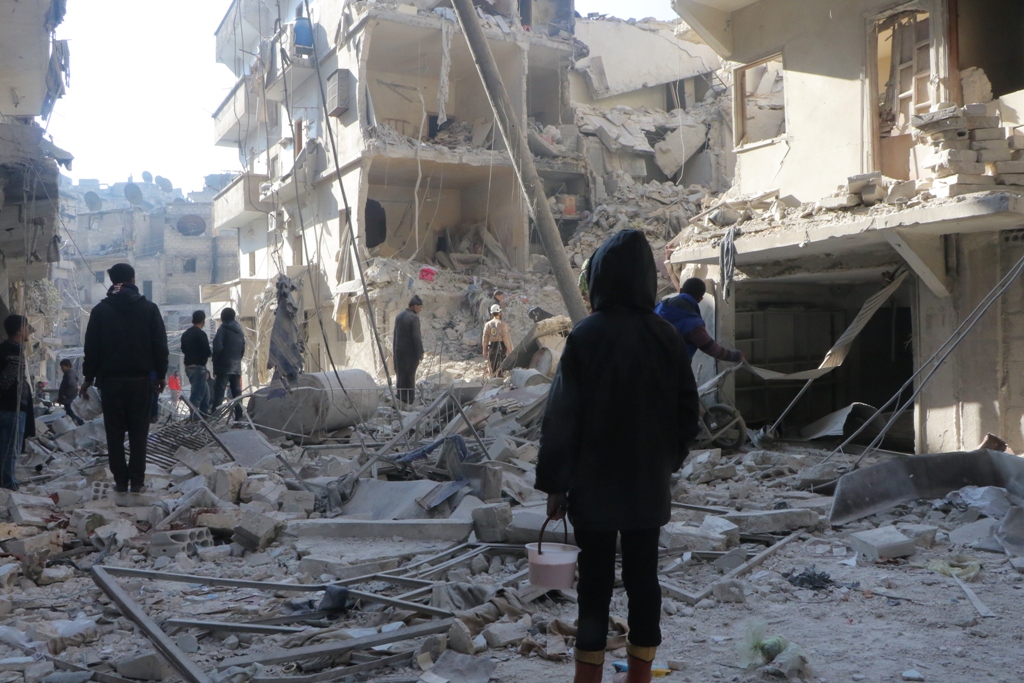 ALEPPO, SYRIA - DECEMBER 04: Search and rescue team members work at site after warcrafts belonging to Syrian army carried out airstrikes on the opposition controlled areas in Aleppo's Sukkeri region, Syria on December 4, 2016. ( Ibrahim Ebu Leys - Anadolu