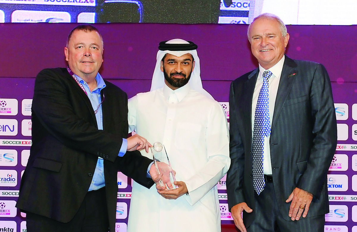 The Secretary-General of Supreme Committee for Delivery and Legacy, Hassan Al Thawadi, presenting the first Duncan Revie Award to Chairman of Sheffield FC, Richard Tims, during the opening ceremony of the Soccerex Asian Forum at the Grand Hyatt Hotel in D