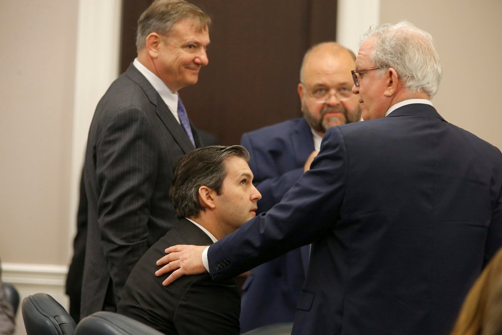Defense attorneys Don McCune (L), Andy Savage and Miller Shealy surround former North Charleston police officer Michael Slager after a note was sent by the jury as they continue to deliberate at the Charleston County court in Charleston, South Carolina, D