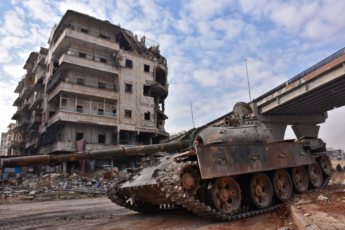 Syrian government troops patrol the newly captured al-Sakhour neighbourhood in the eastern part of the northern city of Aleppo on December 7, 2016. Rebels in Aleppo called for a five-day truce and the evacuation of civilians after losing more than three q