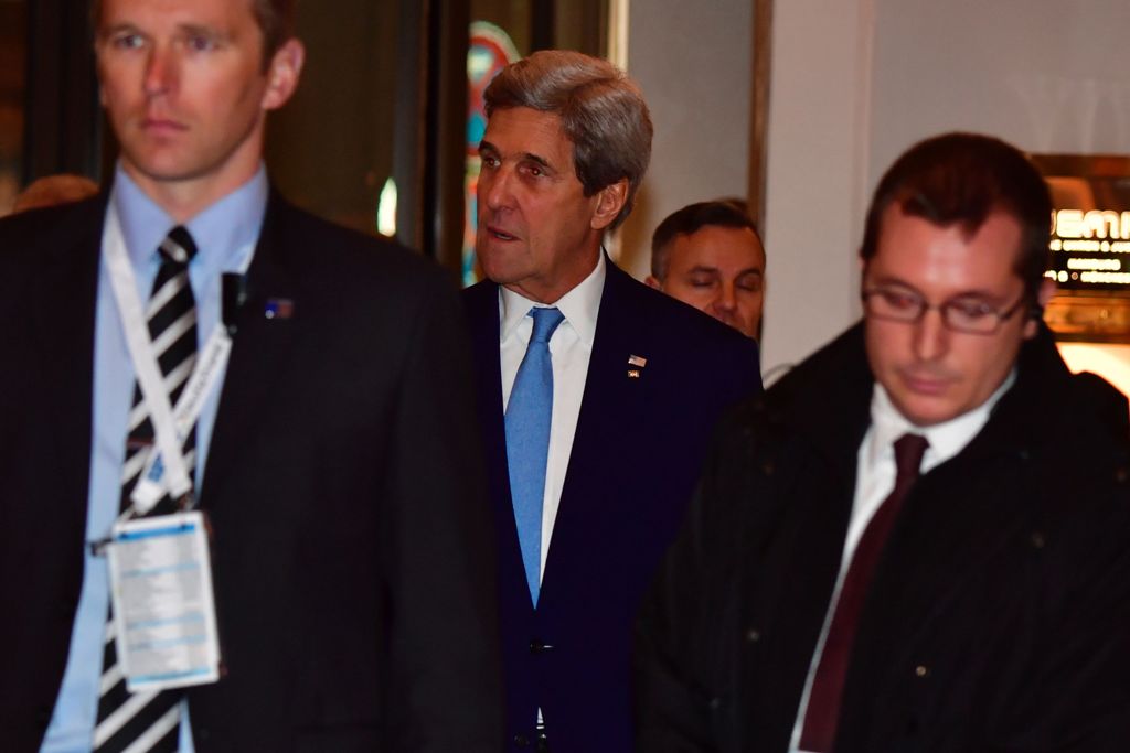 US Secretary of State John Kerry (C) arrives ahead of the two-day foreign ministers' meeting of the Organisation for Security and Cooperation in Europe (OSCE) in Hamburg, northern Germany, on December 7, 2016. / AFP / John MACDOUGALL
