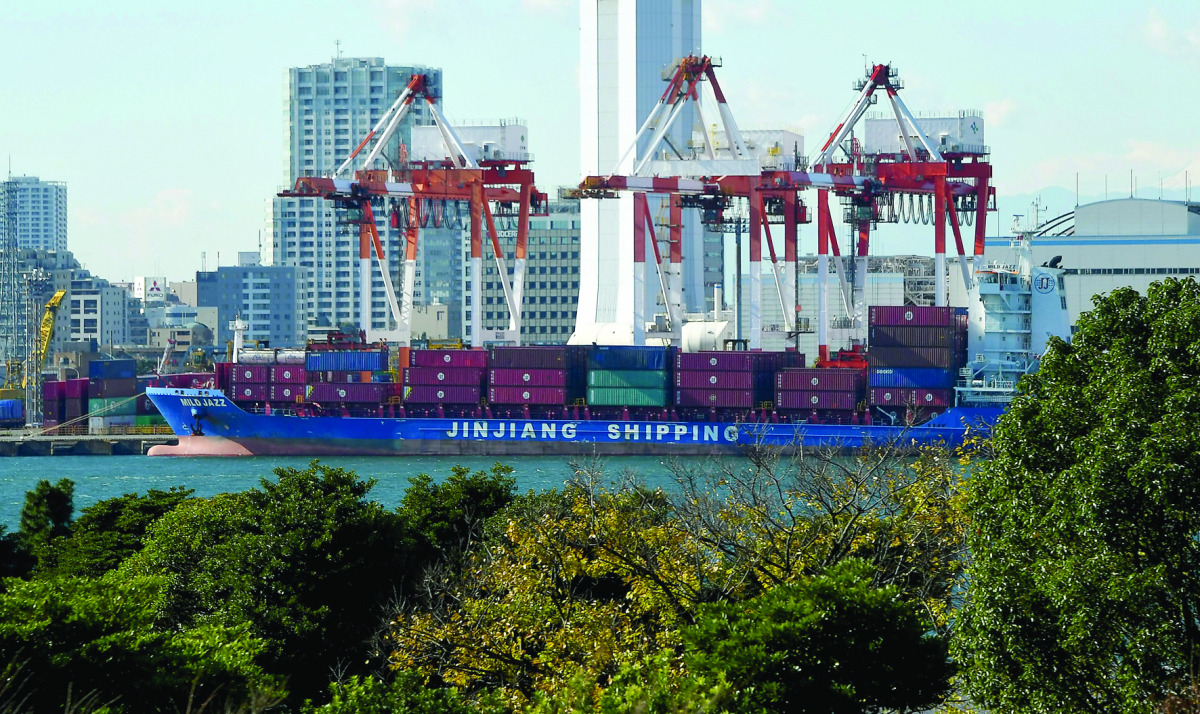 A freighter moors at the container yard in Tokyo yesterday.