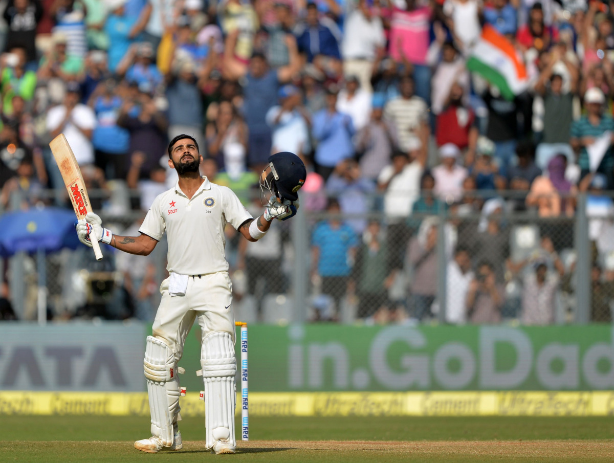 India's captain Virat Kohli celebrates after scoring a century (100 runs) during the third day of the fourth Test cricket match between India and England at the Wankhede stadium in Mumbai on December 10, 2016. (AFP / Punit PARANJPE)