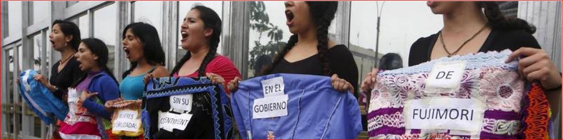 Women, with their bodies painted with blood, hold signs reading: 