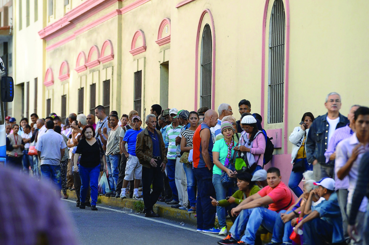 People queue outside Venezuela's Central Bank (BCV) in Caracas in an attempt to change 100 bolivar notes, yesterday.
