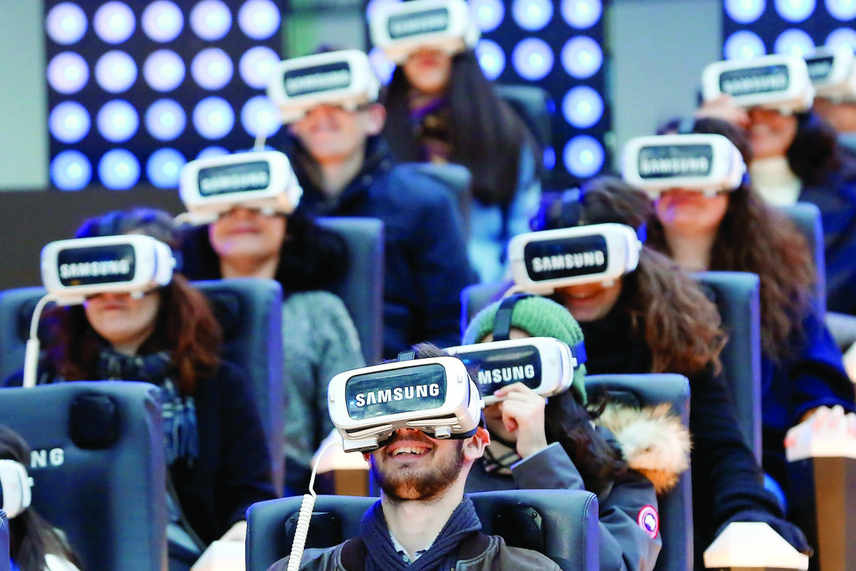 People test virtual reality Samsung Gear VR glasses at the Grand Palais exhibition hall as part of Christmas holiday season animations in Paris.