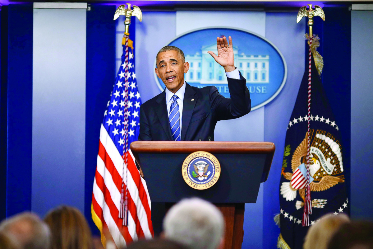 US President Barack Obama waves good bye at the conclusion of his last news conference of the year at the White House before leaving for his annual Hawaiian Christmas holiday in Washington.