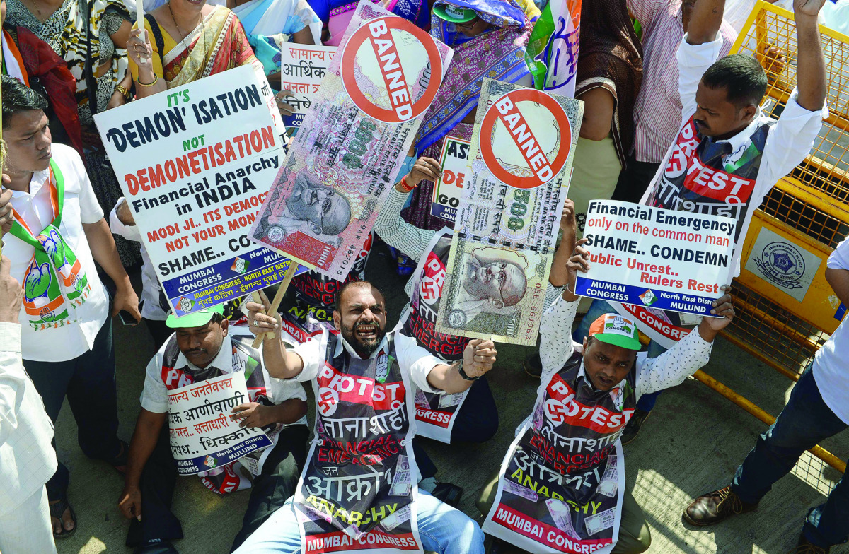 People hold placards of banned 500 and 1000 rupee notes during a protest against demonetisation, in Mumbai, yesterday. 