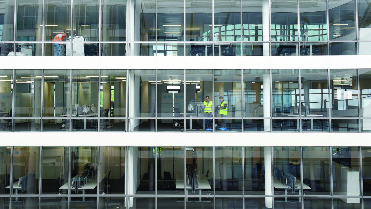 Men working at an office building in Munich, southern Germany.