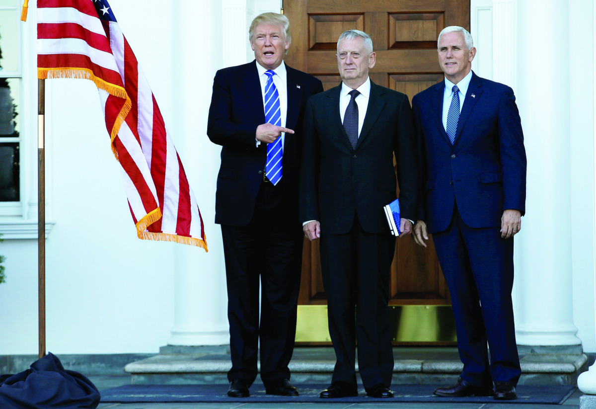 US President-elect Donald Trump (left) and Vice President-elet Mike Pence (right) greets retired Marine Gen. James Mattis at the main clubhouse at Trump National Golf Club in Bedminster, New Jersey.
