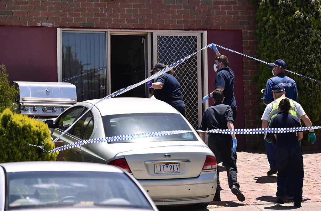 Police walk towards a door as they search a house in the Melbourne suburb of Meadow Heights, Australia, December 23, 2016 during an operation regarding a plot to attack prominent sites in central Melbourne with a series of bombs on Christmas Day that auth