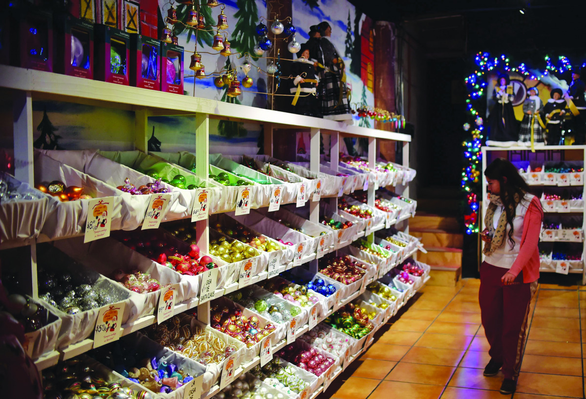 A woman looks at Christmas ornaments at a shop in Tlapujahua, Michoacan State, Mexico