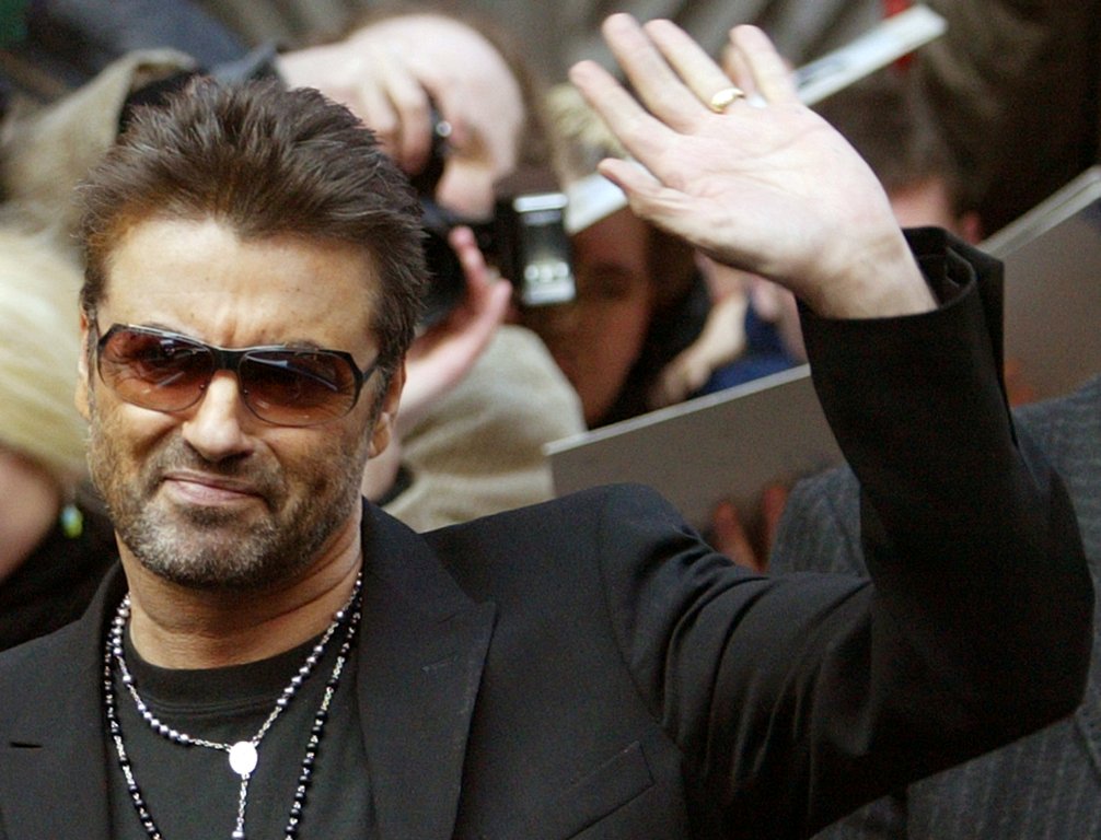 British singer and actor George Michael waves as he leaves a news conference to introduce the film 'George Michael: A Different Story' by Southan Morris which is not part of the competition at the 55th Berlinale International Film Festival in Berlin Febru