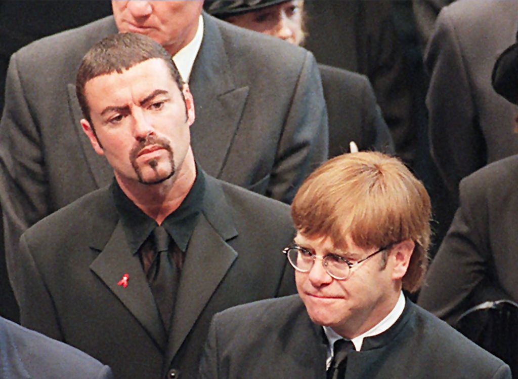(FILES): This file photo taken on September 6, 1997 shows pop stars George Michael (L) and Elton John (R) leaving Westminster Abbey following the funeral service of Diana, Princess of Wales.  AFP / JOHNNY EGGITT

