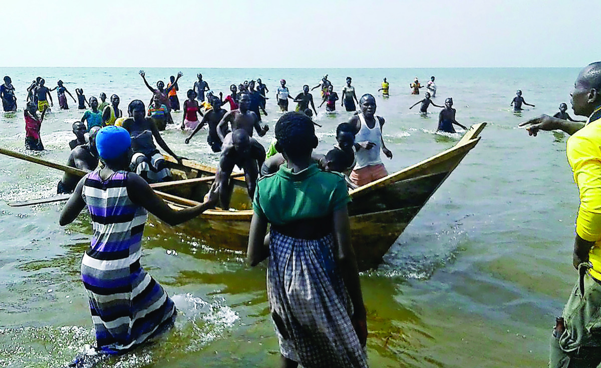 Survivors of a boat accident come back ashore on Lake Albert, in Buliisa, yesterday.