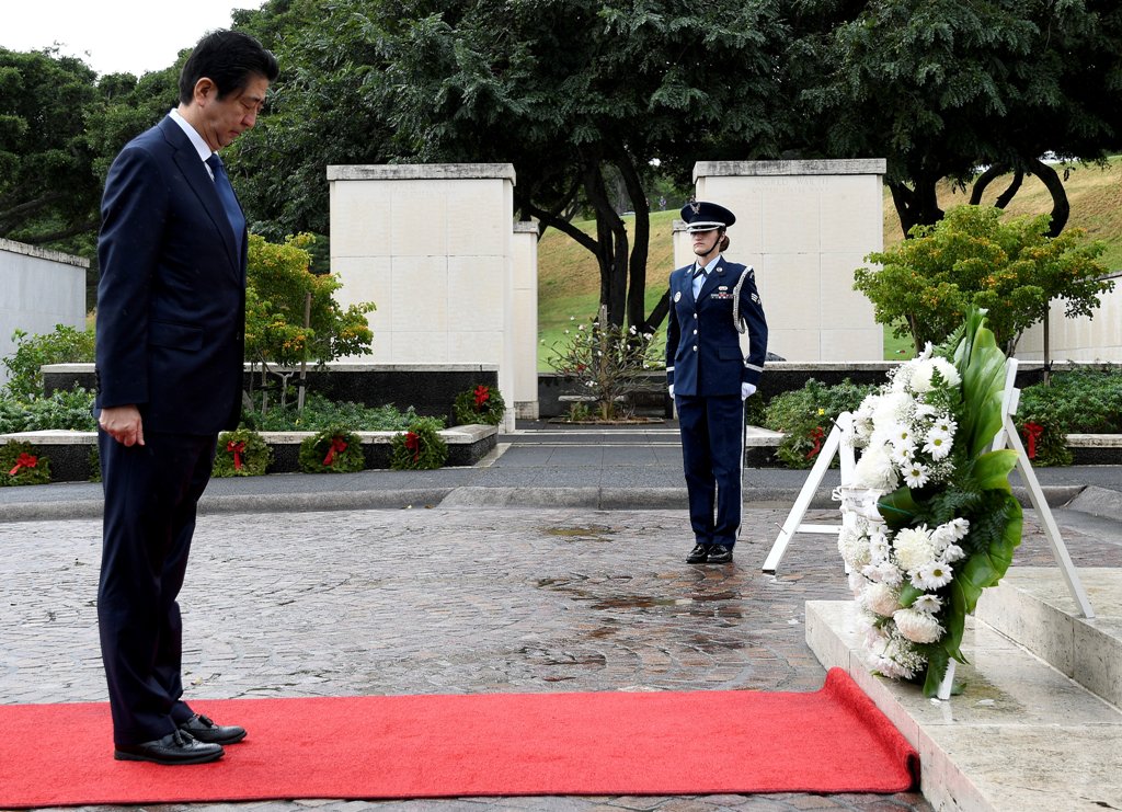 Japanese Prime Minister Shinzo Abe bows his head after presenting a wreath at the National Memorial Cemetery of the Pacific at Punchbowl in Honolulu, Hawaii, U.S. December 26, 2016. REUTERS/Hugh Gentry
