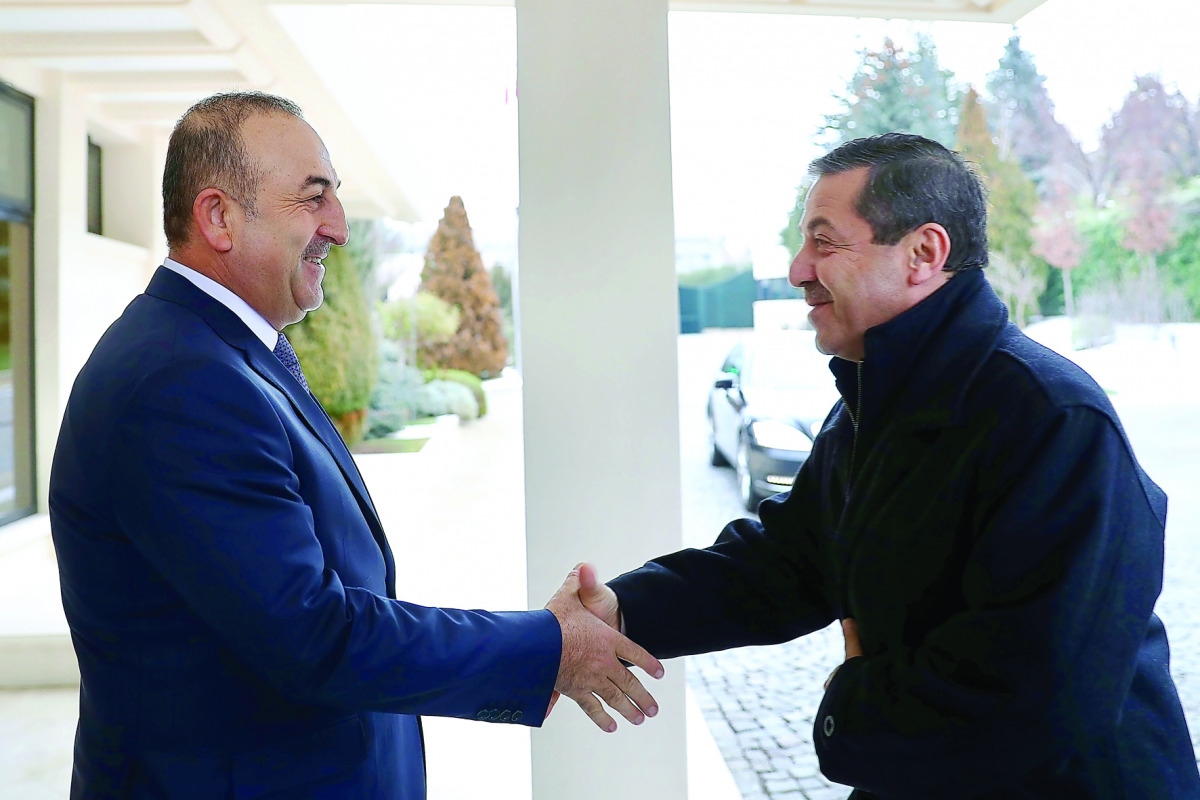 Turkish Foreign Minister Mevlut Cavusoglu (left) welcomes Turkish Republic of Northern Cyprus (TRNC) Foreign Minister Tahsin Ertugruloglu prior to their meeting in Ankara, Turkey, yesterday. 