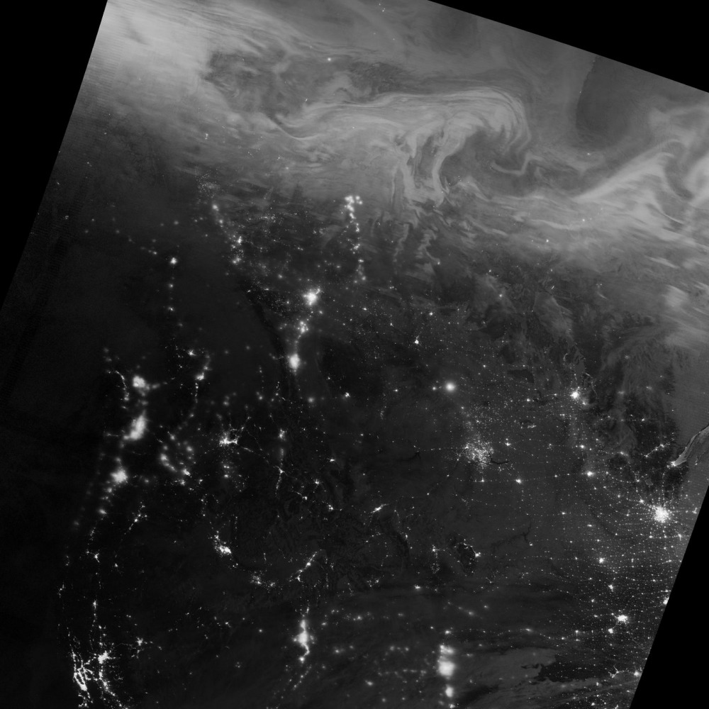 The northern lights — the swirling, cloud-like features in this image — stretched across northern Canada during the nighttime hours of Dec. 22, 2016. Jesse Allen / NASA Earth Observatory
