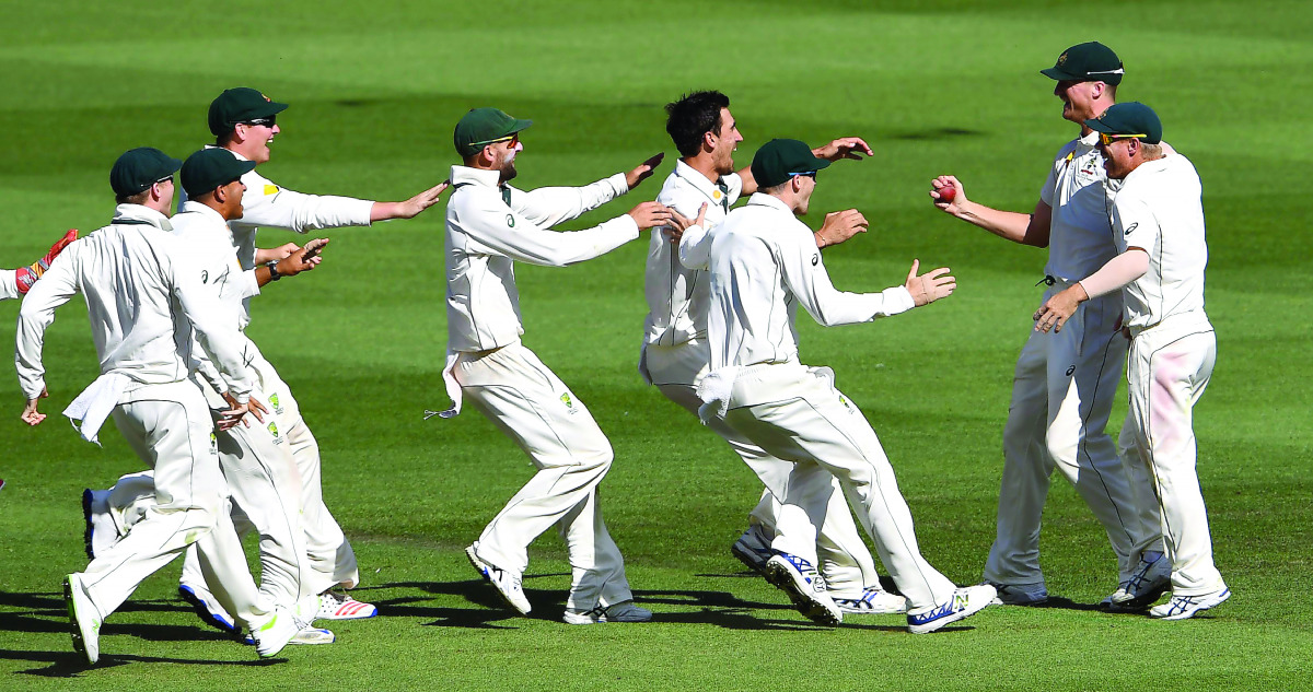 Australian players rush to embrace team-mates Josh Hazlewood (2right) and David Warner (right) after Australia defeated Pakistan on the final day of the second cricket Test match in Melbourne, Australia yesterday.