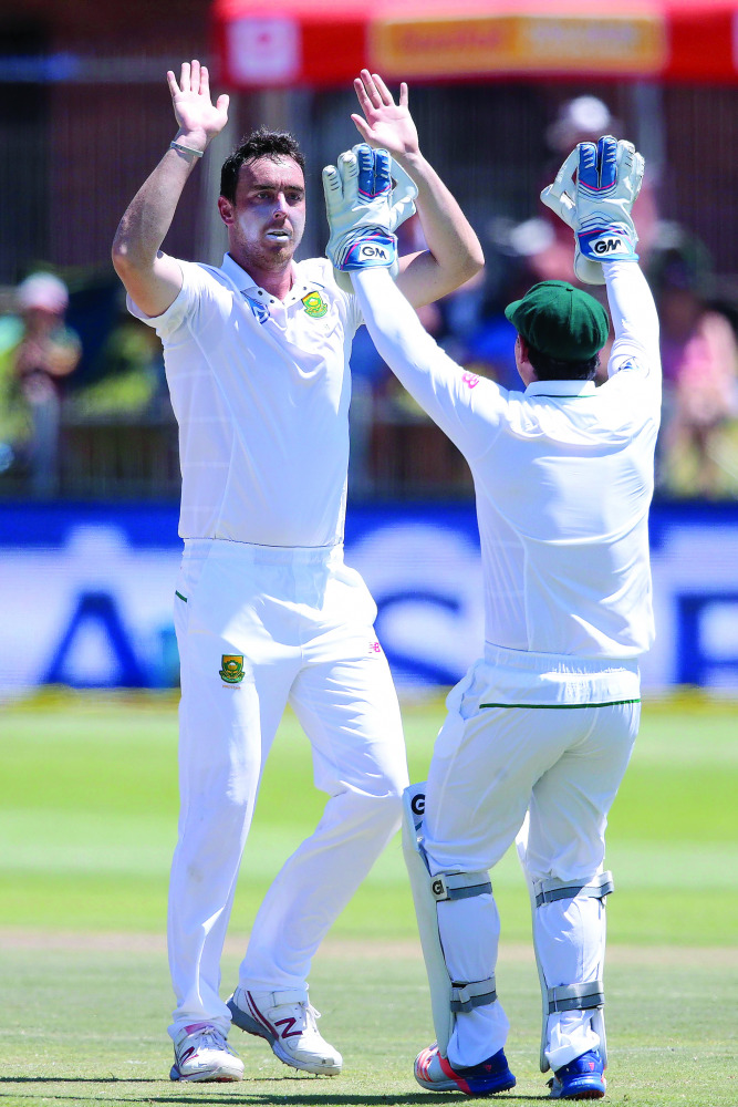 South African bowler Kyle Abbott (left) celebrates with a team-mate their win against Sri Lanka during the fifth and last day of the first Test at St George's Park ground in Port Elizabeth in South Africa yesterday.