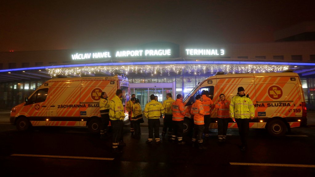 Rescue workers stand in front of the Vaclav Havel Airport after a passenger jet flying from Spain to Warsaw made an emergency landing due to a bomb threat, in Prague, Czech Republic, December 30, 2016. REUTERS/David W Cerny

