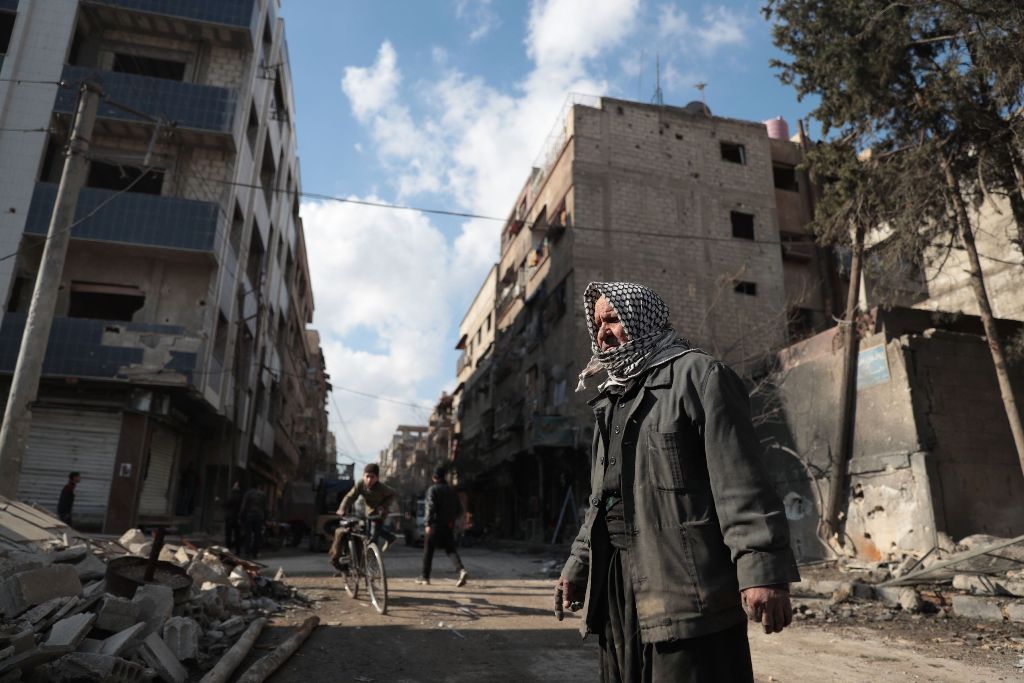 Syrian Abu Khaled looks at the rubble of his destroyed house in the rebel-held town of Douma, on the eastern outskirts of Damascus, on December 30, 2016, on the first day of a nationwide truce. AFP / Abd Doumany
