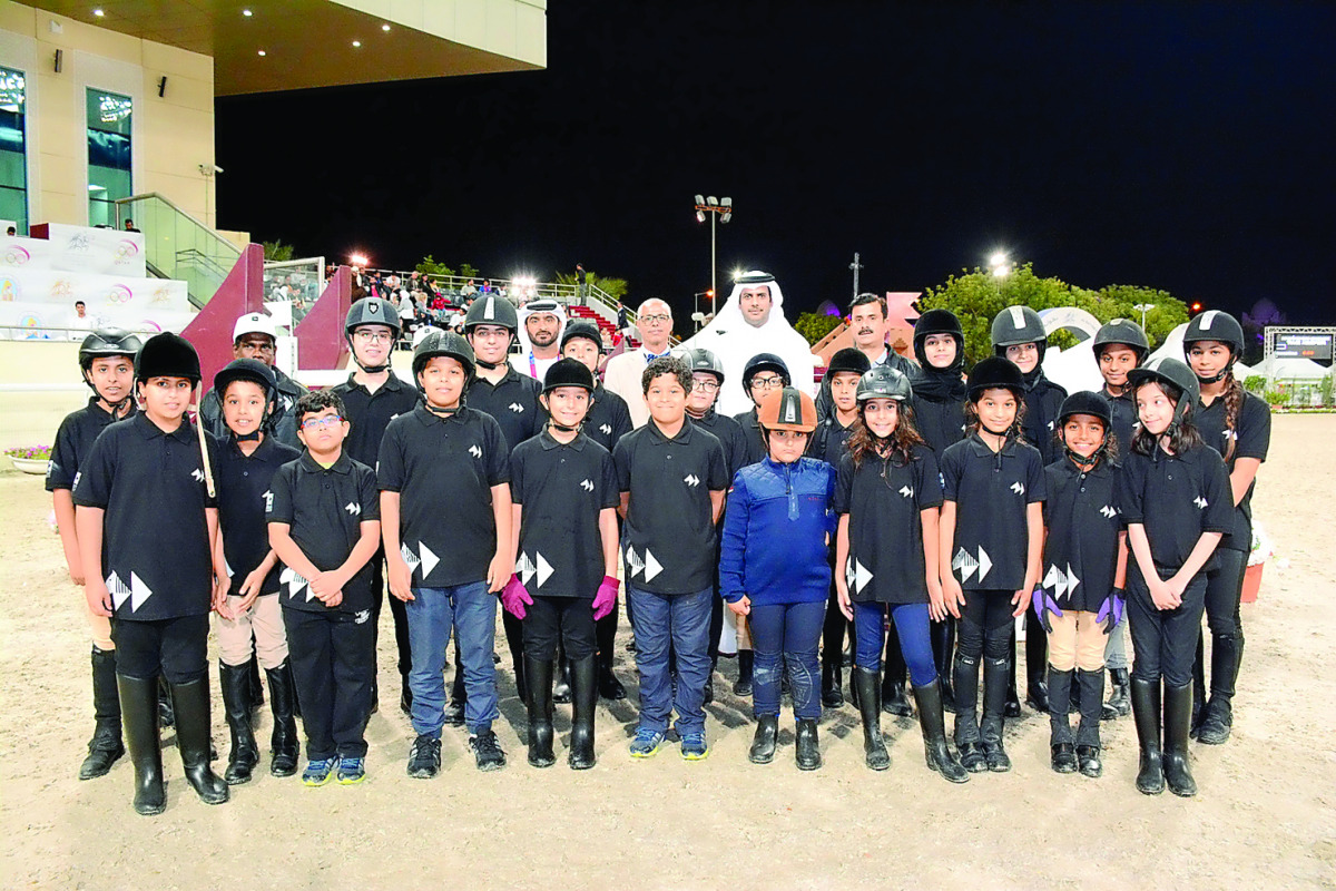 Young riders pose for a picture with Qatar Equestrian Federation (QEF) officials during the Al Rayyan International Show Jumping Championship at QEF's Main Arena.