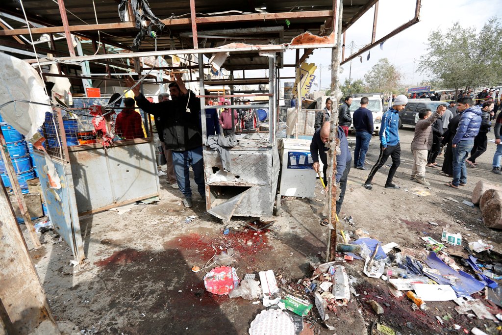 People look at wreckage at the site of car bomb attack in a busy square at Baghdad's sprawling Sadr City district, in Iraq January 2, 2017. REUTERS/Ahmed Saad.