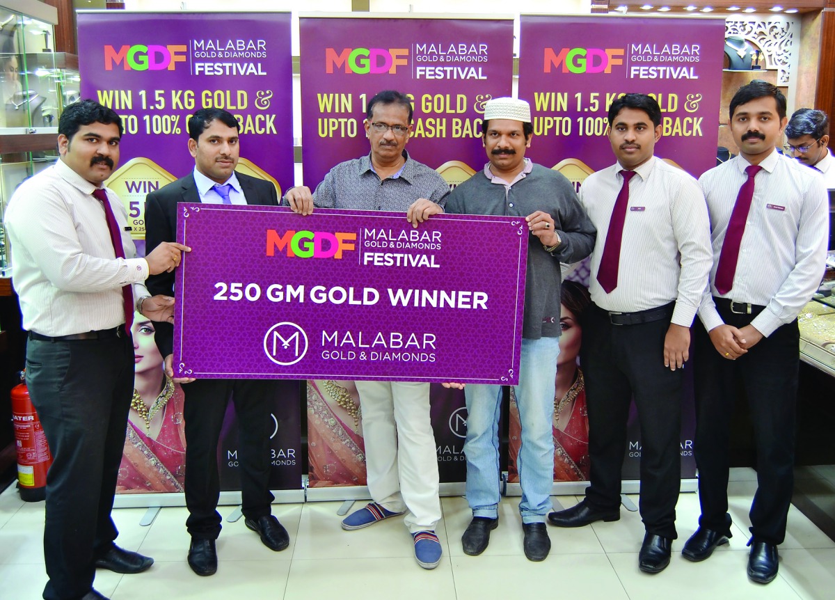 Rafeek, the first raffle draw winner of ‘Malabar Gold & Diamond Festival’’, receives the prize of 250 gramme gold from Saji P K, Branch Manager at Gharafa-Qatar, in the presence of officials from Malabar Gold & Diamonds.