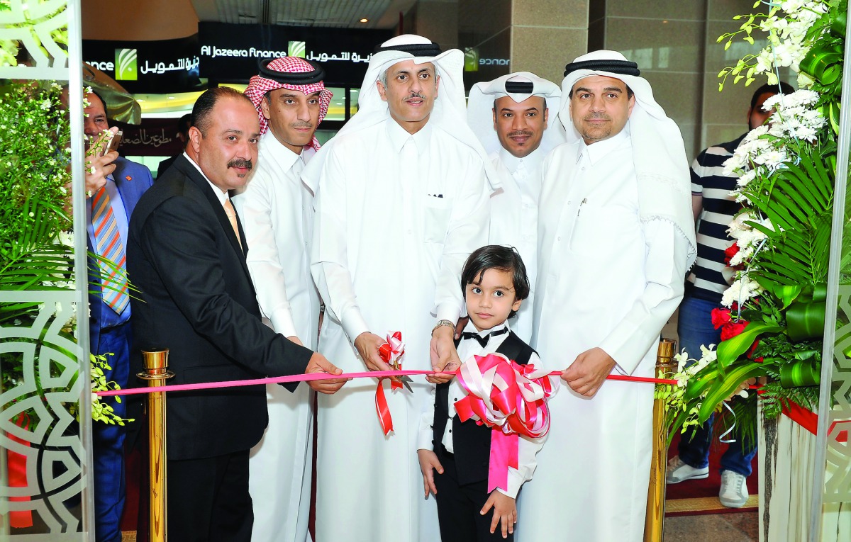Sheikh Dr Khaled bin Thani bin Abdullah Al Thani (cente), Chairman and Managing Director, QIIB; Ahmed Al Shaibei (first right), CEO, QIIB and other senior officials at inauguration ceremony of QIIB's Al Sadd branch, yesterday.  (Pic: Kammutty VP/ The Peni