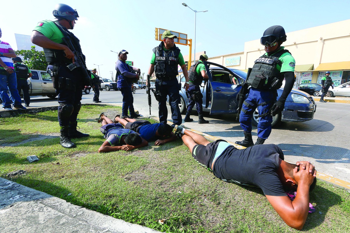 Police detain people for looting while protesting against rising prices of petrol, on the outskirts of Veracruz, Mexico, yesterday.