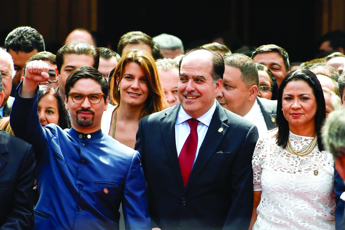 Opposition's parliamentary leader Julio Borges (centre) and First Vice-President of the assembly Freddy Guevara (left) are seen along with supporters during the swearing-in ceremony in Caracas, yesterday.