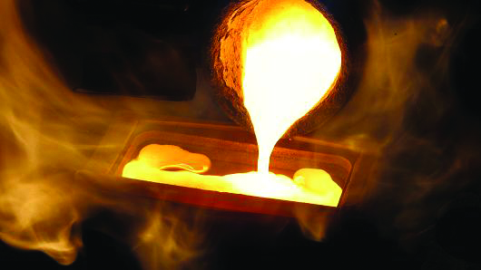 Melted gold flows out of a smelter into a mould of a one kilogram bar at a plant in the Swiss town of Mendrisio.