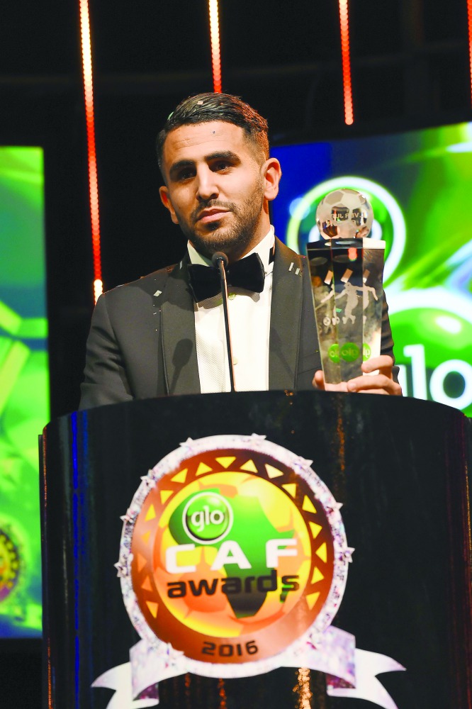 Algerian Riyad Mahrez speaks while holding trophy after being crowned African Footballer of the Year in Abuja, Nigeria on Thursday.