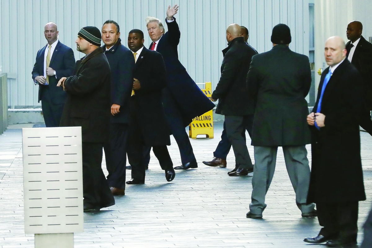 US President-elect Donald Trump along with others exits One World Trade Center in Manhattan, New York City, yesterday.