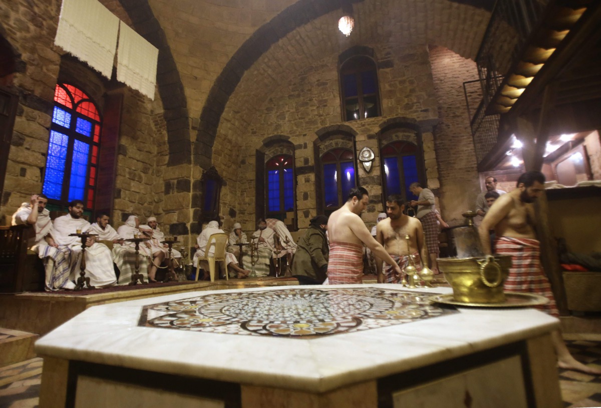 Syrian men visit the Al-Malik al-Zahir Hammam in the capital Damascus on January 7 2017 as an ongoing water crisis continues due to the fighting between government forces and rebel fighters. The elegant Al-Malik al-Zahir hammam dates back to 985 AD but is