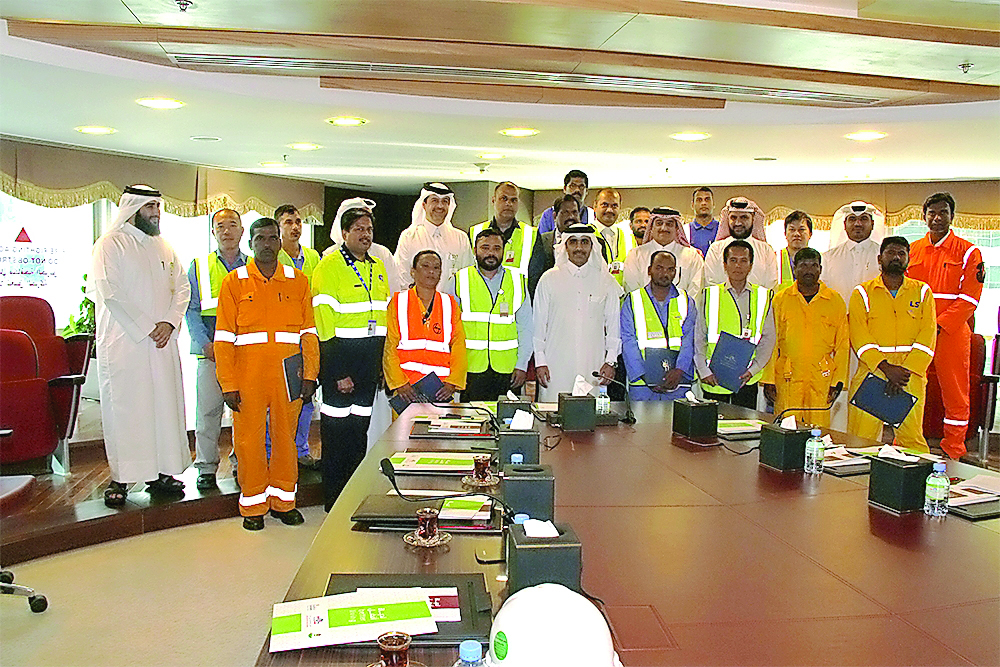 Workers and employees involved in the Project X of Kahramaa for expansion of electricity network with their certificates. 