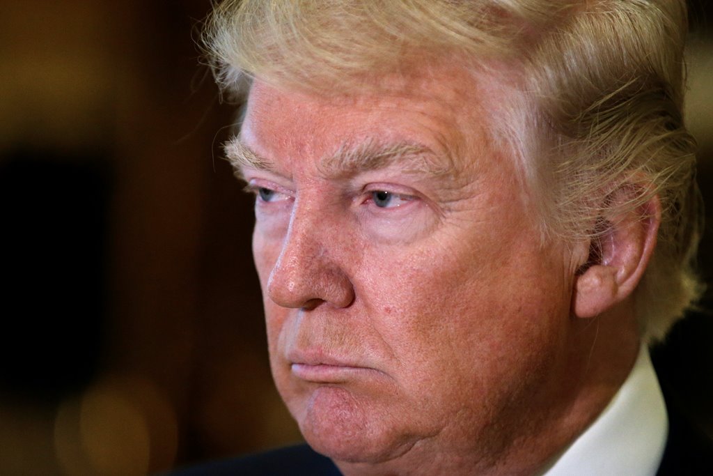 File Photo: U.S. President-elect Donald Trump listens to questions from reporters in the lobby at Trump Tower in New York, U.S., January 9, 2017. REUTERS/Mike Segar/File Photo
