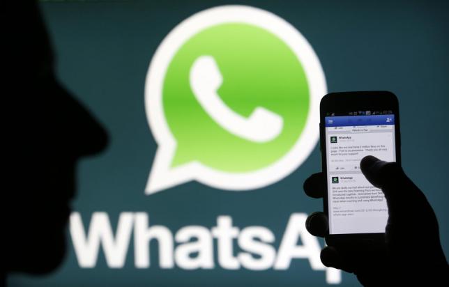 A Whatsapp App logo is seen behind a Samsung Galaxy S4 phone that is logged on to Facebook in the central Bosnian town of Zenica, February 20, 2014. Reuters