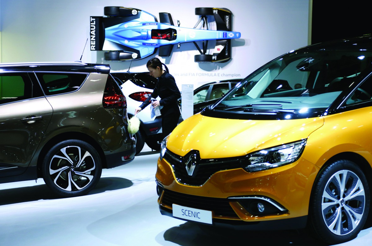 A worker cleans a Renault car at the European Motor Show in Brussels, Belgium, yesterday.